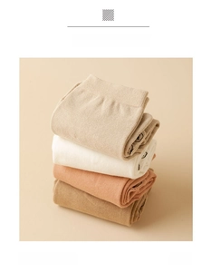 Detail showing stack of four Morandi toned cotton five-finger socks with ribbed cuffs
