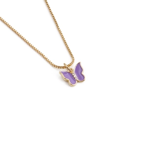 Detail of gold box chain necklace with purple butterfly pendant and small zircon stones