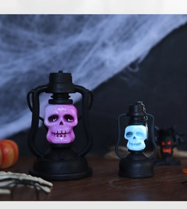 Detail of Halloween LED skull lanterns with purple and blue glowing lights on wood surface