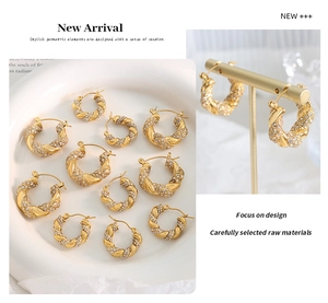 Macro detail of twisted gold U-shaped hoop earrings with pave cubic zirconia accents
