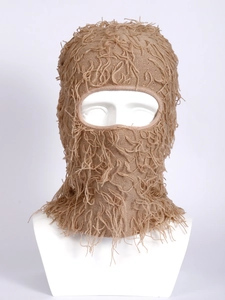 Detailed knit texture and unique tassel trim on a khaki knitted balaclava mask