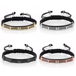 Detail of four adjustable braided bracelets with textured metal bars in four metallic finishes