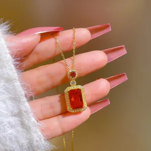 Close-up of luxury gold titanium steel necklace with rectangular red ruby pendant