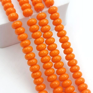 Macro shot of 8x5mm orange glass abacus beads on strings for DIY jewelry making