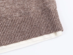 Detail of contrast layered hem with brown marl knit and white fabric lining