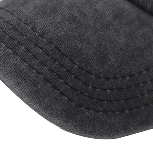 Detailed macro view of the parallel stitching on a washed cotton baseball cap brim