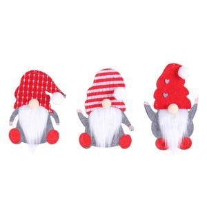 Three Christmas gnome cutlery holders in red and grey felt for festive table decoration