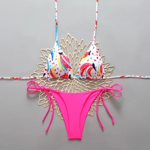 Detail of banana print halter bikini top and neon pink tie-side high cut bottoms