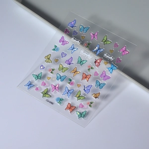 Macro detail of 5D embossed butterfly nail stickers with 3D resin texture on tray