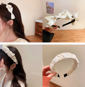 Detail of white fabric headbands with elegant pearls and chic bow design textures