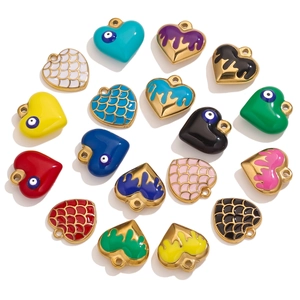 Detail of colorful stainless steel heart pendants with enamel oil drips and dragon scale patterns