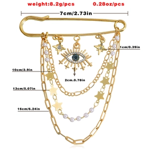 Detailed view of evil eye brooch dimensions with gold stars and pearl tassels