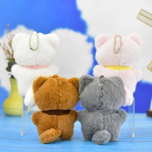 Back view showing four colorful plush cat keychains in white pink brown and grey colors