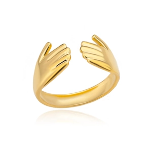 Detail shot of golden hugging hands ring with adjustable opening and polished finish
