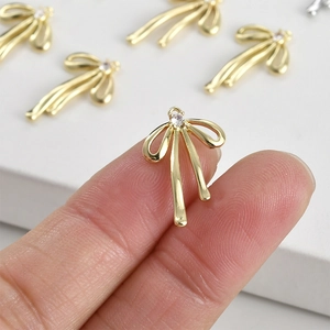 14k gold-plated bow pendant with small rhinestone detail for DIY jewelry making