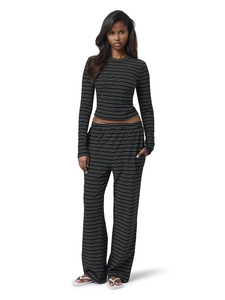 Close-up of black and white striped knit fabric and slim-fit long sleeve top texture