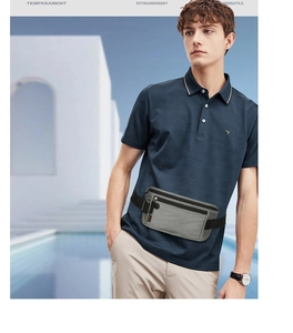 Gray waterproof running belt bag worn by male model in a modern outdoor setting