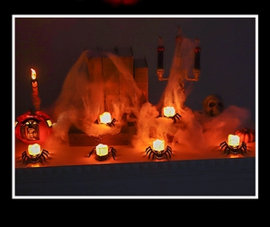 Close-up of Halloween LED pumpkin lights and black spider web decor for festive party setup