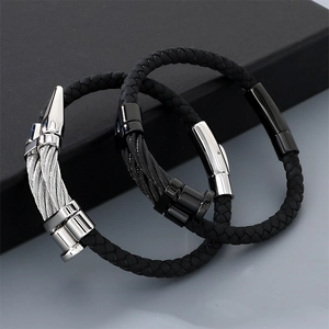 Detail of punk style braided leather bracelets with stainless steel nail head design.