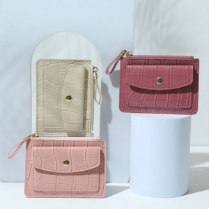 Crocodile pattern PU leather wallet in beige and pink tones on geometric display stands