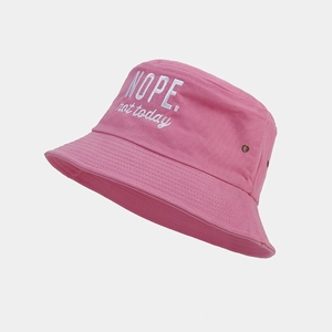 Close-up of pink cotton bucket hat with white NOPE. not today embroidery and metal eyelets