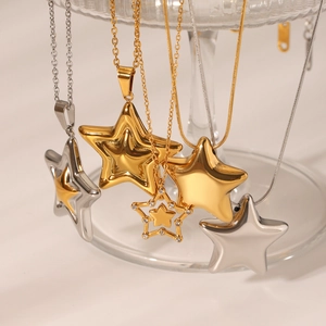 Detailed display of assorted star pendant necklaces in gold and silver finishes with crystal