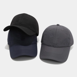Detailed view of quick-dry baseball caps in black, navy blue and dark grey variants