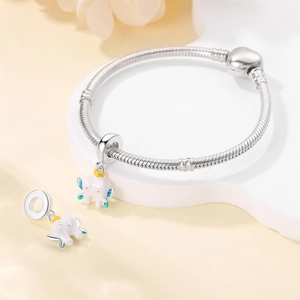Silver snake chain bracelet with heart clasp and enamel tooth charm with golden crown