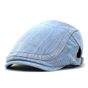 Detail of washed blue denim beret featuring brown stitching and metal adjustable buckle
