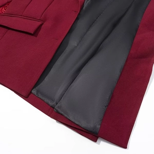 Detailed macro view showing the black inner lining and texture of the burgundy wool blazer