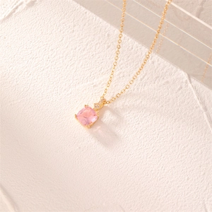 Detail of square pink zircon pendant on a delicate gold chain with subtle stone accents
