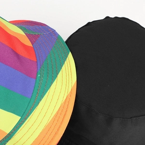 Detail shot of rainbow striped and black reversible cotton fabric texture of the bucket hat