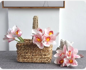 Detailed close-up of 3D printed pink artificial orchids in a woven basket for home decor