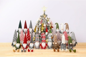Detailed view of various Christmas gnomes with plaid hats and faux fur beards on a wood table