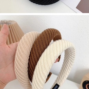 Close-up of knit texture headbands in beige and brown with handmade woven label detail