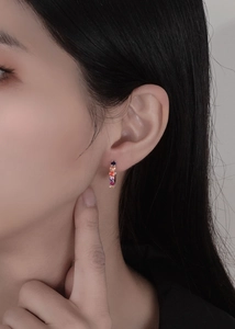 Detail of 925 sterling silver hoop earrings with rainbow cubic zirconia inlay on model