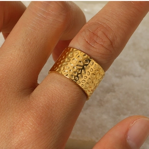 Macro shot of 18k gold plated stainless steel wide ring with hammered honeycomb texture