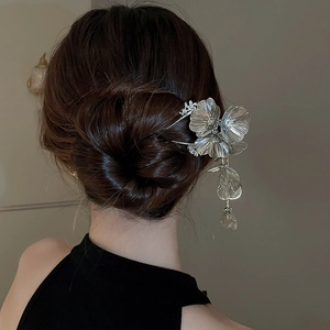 Detail of silver floral hair pin with sparkling tassels styled in a classic bun
