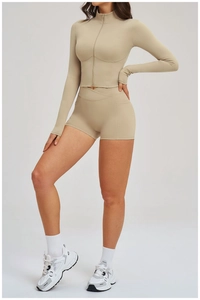 Detail of high-waist fitness shorts with V-cross waistband and smooth matte finish