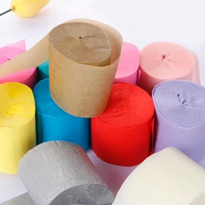 Close-up of colorful crepe paper rolls in pink, yellow, blue and white for party decor