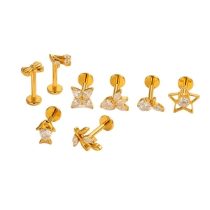 Titanium piercing jewelry set with gold bow and heart studs featuring clear zircon stones