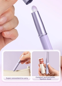 Close-up of portable lavender mini lip brush with protective cap and retractable metal handle