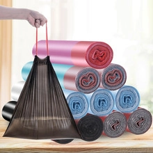 Close-up of durable colored plastic garbage bags with handles for easy kitchen waste disposal