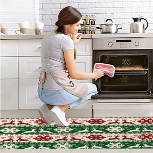 Detail of a Christmas kitchen rug with reindeer patterns used in a modern kitchen scene