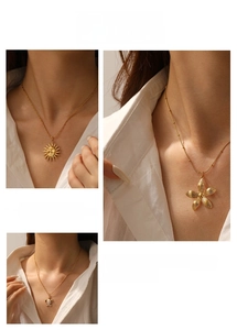 Detailed view of vintage gold-plated necklaces with sun, flower, and turtle pendants