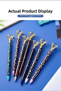 Top view of seven leopard print pens with large crystal diamonds on a blue background
