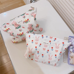 Close-up of cotton storage pouch with cute rabbit print and top zipper closure