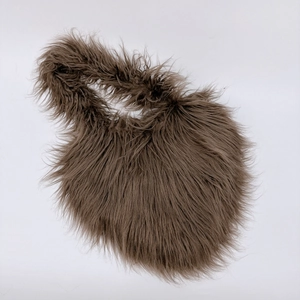 Detailed top view of a dark brown faux fur heart shaped crossbody bag with fluffy texture