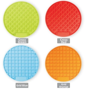 Macro view of four colorful silicone pet slow feeder mats with cross and grid textures