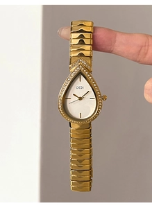 Close-up of GEDI teardrop watch dial with sparkling diamonds and gold metal chain